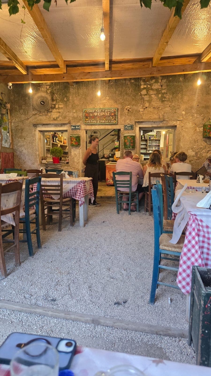 Diners eating under the pergola at O Foros in Old Perithia